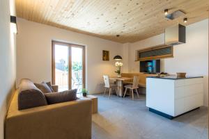 a living room and kitchen with a couch and a table at Eco Bnb & Apartments Bründlerhof in Marlengo