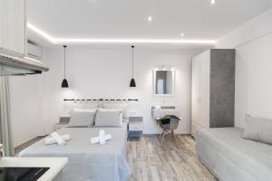 a bedroom with two beds and a couch at Skalidis Apartments Stalis in Stalida