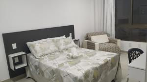 Säng eller sängar i ett rum på Concept Tower Praia Apart