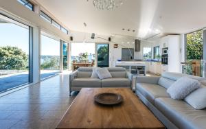 a living room with a couch and a table at Tui Point in Surfdale