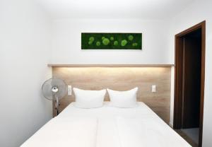 Postel nebo postele na pokoji v ubytování Hotel Perlach Allee by Blattl