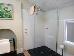 a bathroom with a shower, toilet, and sink at Faversham House in York