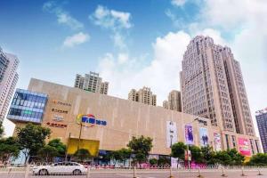 a car parked in front of a building with tall buildings at Gallery F Hotel in Wuhan