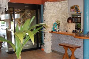 a woman standing at a counter in a restaurant at Amami Resort Bashayamamura in Amami