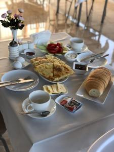 a table with food and cups and plates of food at Hotel Chakvi in Chakvi