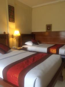 Postel nebo postele na pokoji v ubytování Melasti Beach Resort & Spa Legian