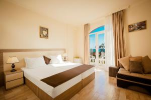 a hotel room with a bed and a window at Iveria Elli Hotel in Shekhvetili