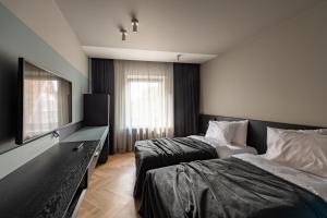 Кровать или кровати в номере Maestro Design Hotel