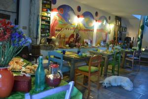 a dining room with tables and a dog sleeping on the floor at ValdericArte in Lamoli Di Borgo Pace