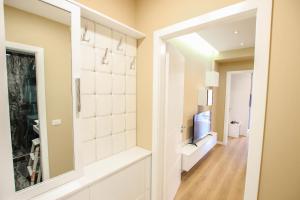 a hallway with a mirror and a television at Brilant Luxury Apartment in Gjirokastër +20 photos