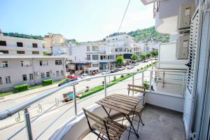 a balcony with two chairs and a view of a street at Brilant Luxury Apartment in Gjirokastër