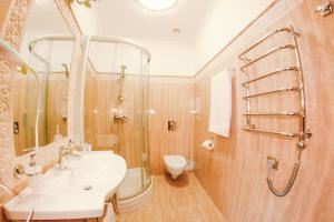 a bathroom with a sink and a shower and a toilet at Hotel Helicopter in Kremenchuk