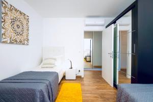 Postel nebo postele na pokoji v ubytování Stella Apartment