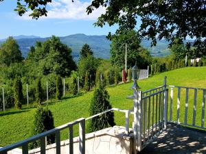a porch with a fence and a view of a field at Villa BS Sarajevo in Sarajevo