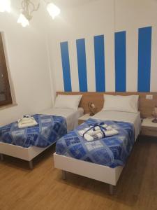 Postel nebo postele na pokoji v ubytování b&b binario nove e tre quarti