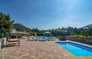 a patio with tables and chairs and a swimming pool at Villa Rinascimento Depandance in Lucca