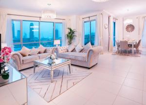 a living room with two couches and a table at Elite Royal Apartment - Full Burj Khalifa & Fountain View - 2 bedrooms and 1 open bedroom without partition in Dubai