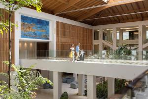 a group of people walking through a building at Hipotels Barrosa Park in Chiclana de la Frontera