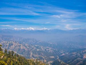 a view of a mountain range with snow capped mountains at Mount Princess Hotel in Dhulikhel