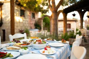 a table with plates of food on top of it at Golden Bay Beach Hotel in Larnaca