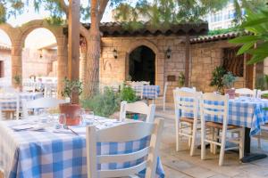 a table with a blue and white checked table cloth at Golden Bay Beach Hotel in Larnaca