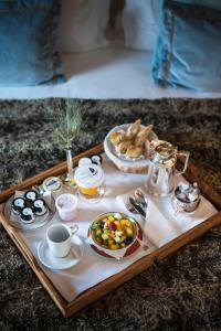 a tray of breakfast foods and coffee on a table at Hôtel Les Barmes De l'Ours in Val dʼIsère