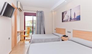 Posteľ alebo postele v izbe v ubytovaní Hotel Olympia Ronda I