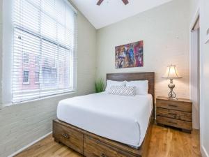 a bedroom with a large bed and a window at Modern Condos near French Quarter & Bourbon Street in New Orleans