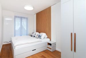 Postel nebo postele na pokoji v ubytování Apartments Residence Grand