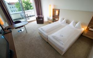 Ein Bett oder Betten in einem Zimmer der Unterkunft Cityhotel D&C St.Pölten