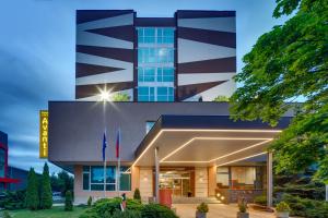 a view of a building with flags in front of it at Avanti Hotel in Brno