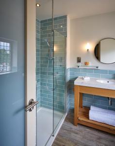 a bathroom with a glass shower and a sink at The Boathouse Inn & Riverside Rooms in Chester