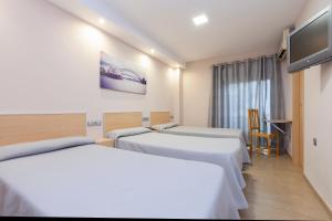 Posteľ alebo postele v izbe v ubytovaní Hotel Olympia Ronda I