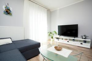 a living room with a couch and a tv at Holiday apartment IVICA in Milohnići