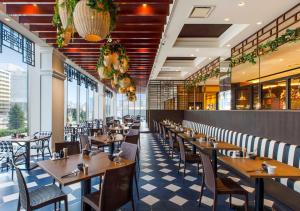 a dining room with wooden tables and chairs at HOTEL＆SPA CENTURY MARINA HAKODATE in Hakodate