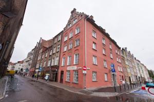 a large red brick building on a city street at Studio Lawendowa in Gdańsk