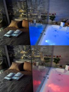 a hotel room with a pool with a view of a city at Nephele Luxury Suite in Thessaloniki