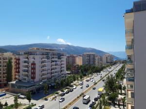 a view of a city street with cars parked at The Place in Vlorë