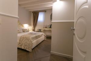 a bedroom with a bed and a room with a window at Ca' Vittoria Apartsuite House Chioggia in Chioggia
