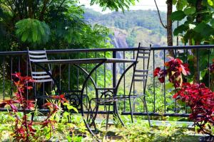 two chairs sitting at a table with a view of a canyon at The Chillout Ella in Ella