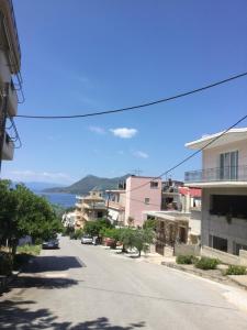 an empty street with buildings and the ocean in the background at Hotel Kallithea in Loutra Edipsou