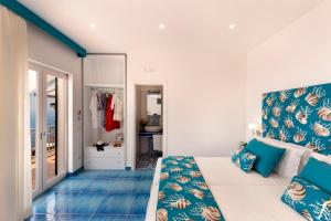a bedroom with a bed and a blue floor at Gala Residence Villa Giovanna in Ravello