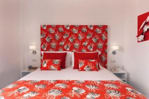 a bed with red pillows and a red headboard at Gala Residence Villa Giovanna in Ravello