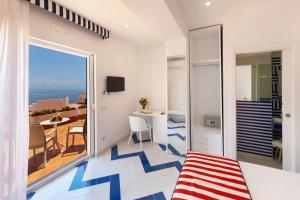 a room with a balcony with a view of the ocean at Gala Residence Villa Giovanna in Ravello