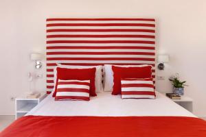 a red and white bed with red and white pillows at Gala Residence Villa Giovanna in Ravello