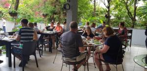 a group of people sitting at tables in a restaurant at Hotel Gori in Kobuleti