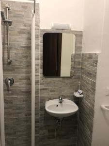 a bathroom with a sink and a mirror at Hotel Mirador in Aulla +41 photos