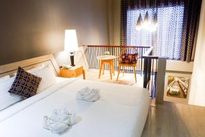 Postel nebo postele na pokoji v ubytování Hatyai Signature Hotel