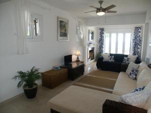 a living room with a couch and a table at Elysium Apartments Corfu in Paleokastritsa