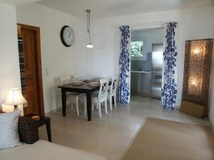 a kitchen and dining room with a table and chairs at Elysium Apartments Corfu in Paleokastritsa